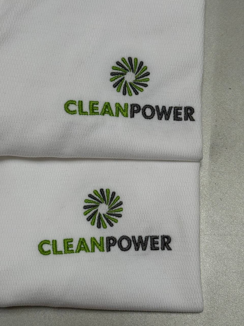 Green and black logo embroidery on white polo fabric